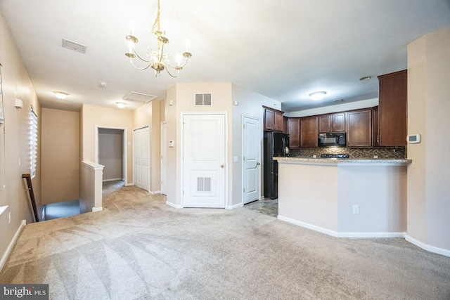 kitchen with tasteful backsplash, black appliances, hanging light fixtures, kitchen peninsula, and light carpet