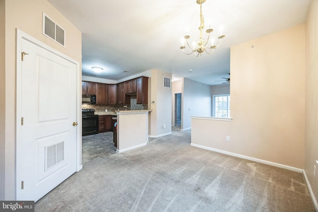 kitchen featuring tasteful backsplash, light colored carpet, decorative light fixtures, and black appliances