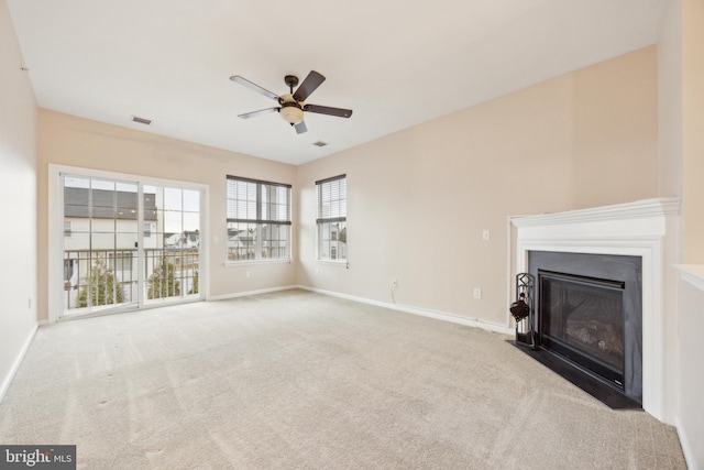 unfurnished living room with light carpet and ceiling fan