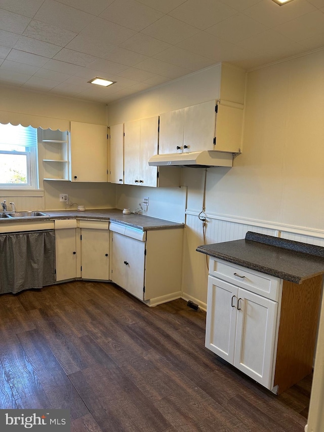 kitchen with dark wood-type flooring, a sink, white cabinetry, open shelves, and dark countertops