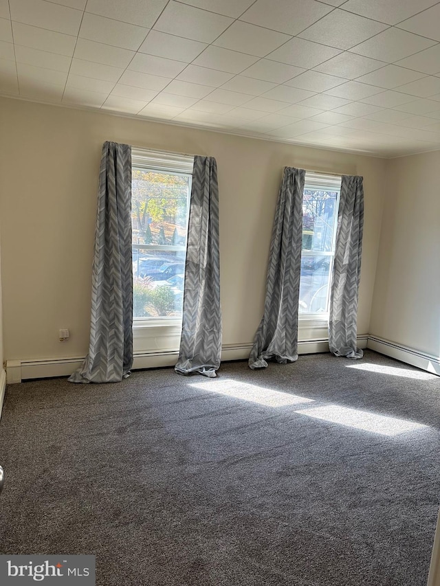 empty room with carpet and a baseboard radiator