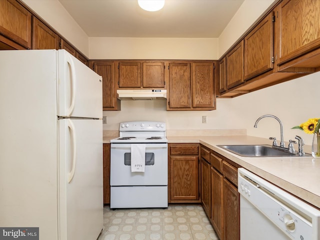 kitchen featuring white appliances and sink