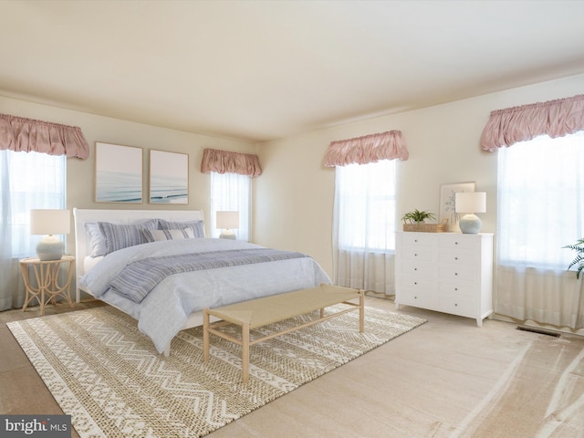 bedroom featuring light carpet