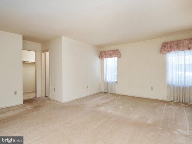 spare room with light colored carpet