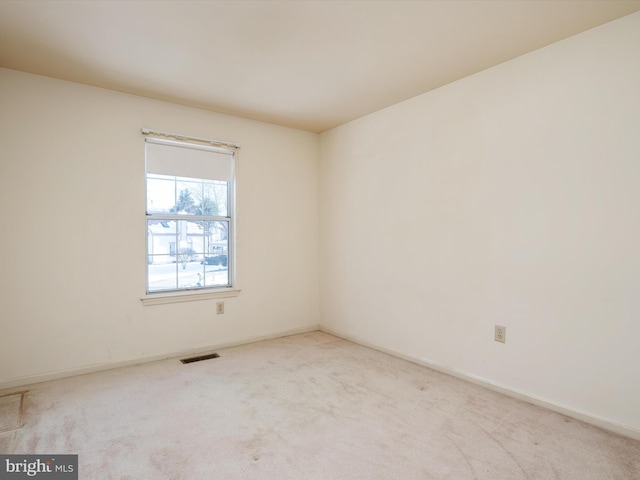 empty room featuring light carpet