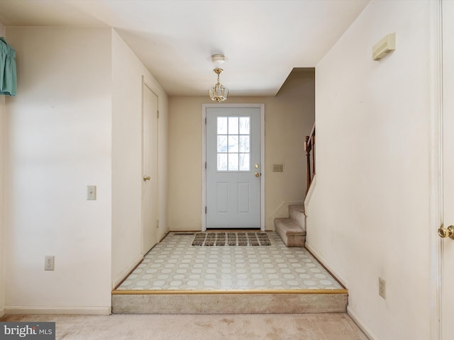 doorway to outside with light colored carpet