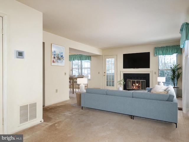 living room featuring a healthy amount of sunlight and light carpet