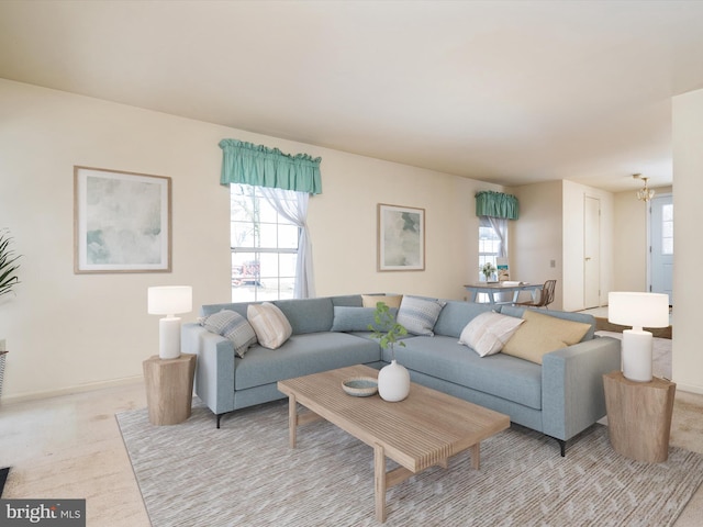 living room featuring a notable chandelier and a healthy amount of sunlight