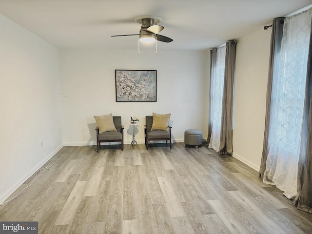 living area with ceiling fan and light wood-type flooring