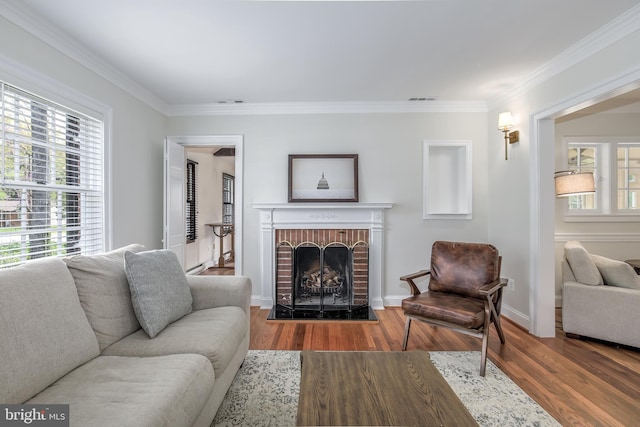 4901 Stillwell Ave, Alexandria, VA 22309 - living room with visible vents, baseboards, a brick fireplace, wood finished floors, and crown molding