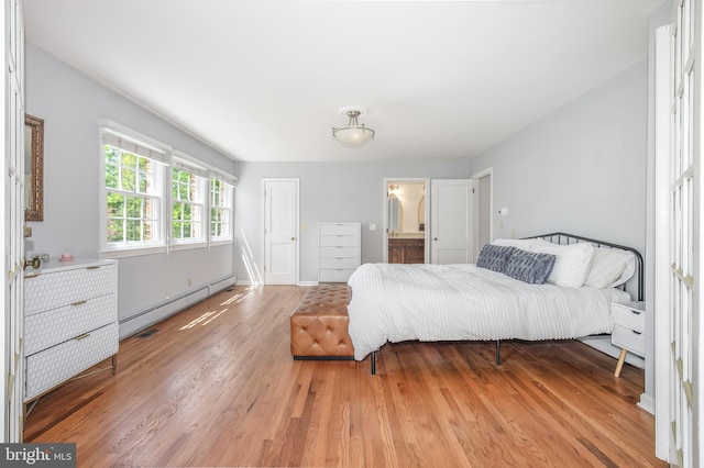 4901 Stillwell Ave, Alexandria, VA 22309 - bedroom featuring light wood finished floors, connected bathroom, and a baseboard radiator