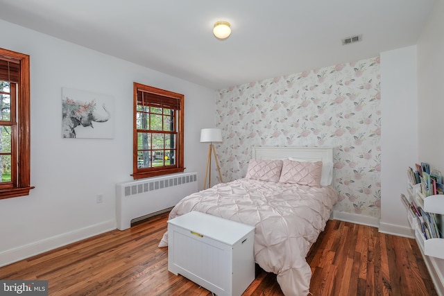 4901 Stillwell Ave, Alexandria, VA 22309 - bedroom featuring radiator heating unit, wood finished floors, baseboards, and visible vents