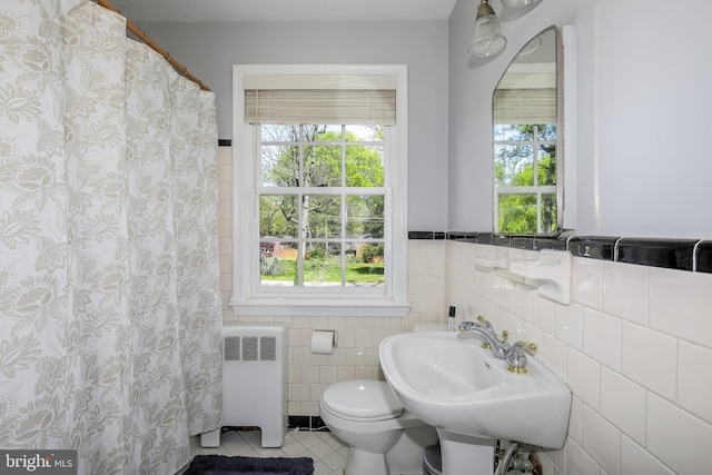 4901 Stillwell Ave, Alexandria, VA 22309 - full bathroom with radiator heating unit, tile patterned flooring, toilet, a sink, and tile walls