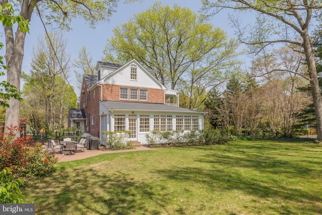 4901 Stillwell Ave, Alexandria, VA 22309 - back of house featuring brick siding, a yard, a patio, and entry steps