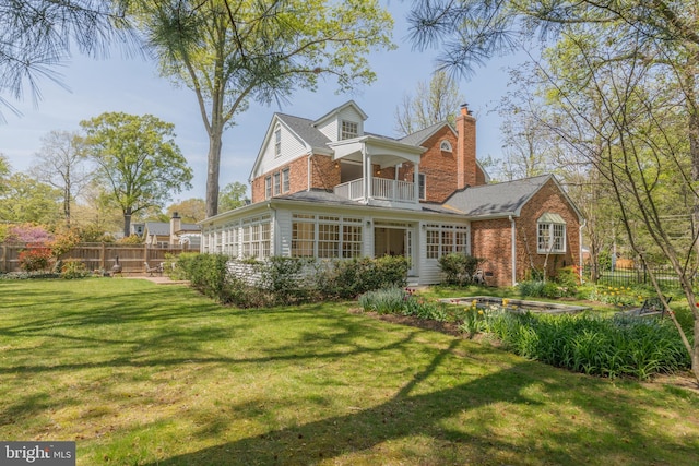 4901 Stillwell Ave, Alexandria, VA 22309 - back of house with a chimney, fence, a balcony, and a lawn