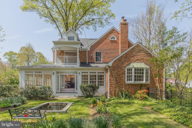 4901 Stillwell Ave, Alexandria, VA 22309 - rear view of property with a chimney, fence, a balcony, a lawn, and brick siding
