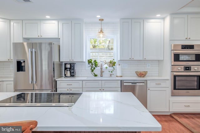 4901 Stillwell Ave, Alexandria, VA 22309 - kitchen featuring white cabinets, stainless steel appliances, a sink, and backsplash