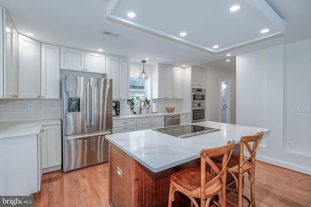 4901 Stillwell Ave, Alexandria, VA 22309 - kitchen featuring visible vents, a sink, light wood-style floors, and appliances with stainless steel finishes