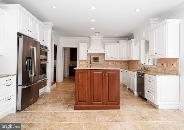 kitchen featuring stainless steel appliances, a center island, premium range hood, and white cabinetry