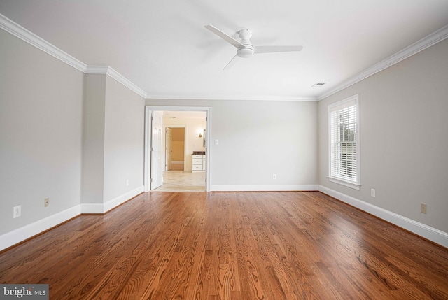 empty room featuring light wood-style flooring, baseboards, ceiling fan, and crown molding