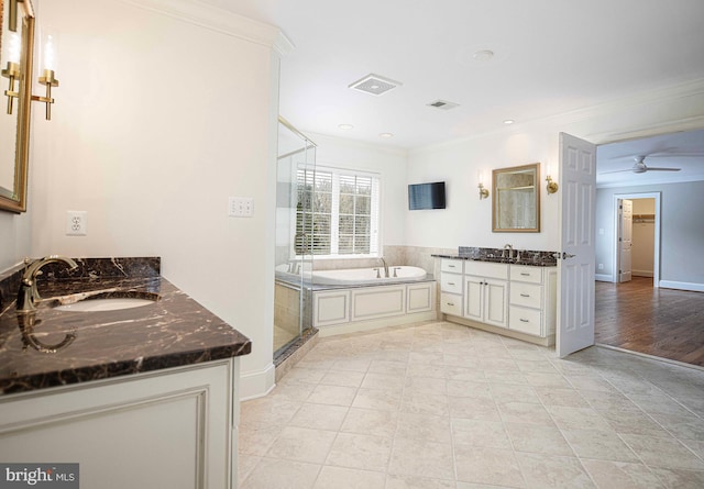 bathroom featuring ornamental molding, two vanities, visible vents, and a sink