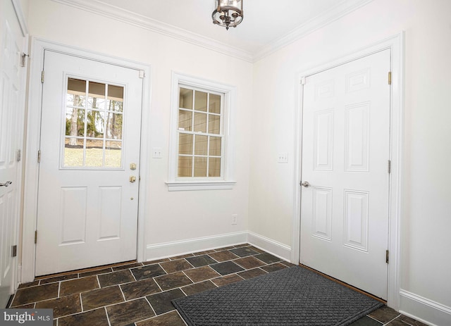 entryway with stone finish floor, baseboards, and crown molding