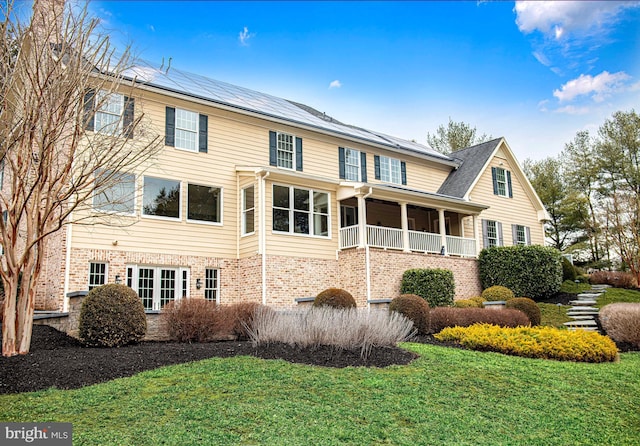 exterior space with brick siding and a lawn