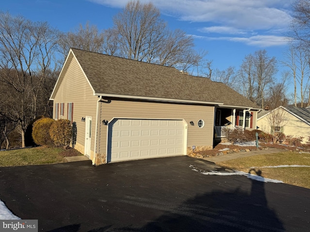 exterior space featuring covered porch and a garage