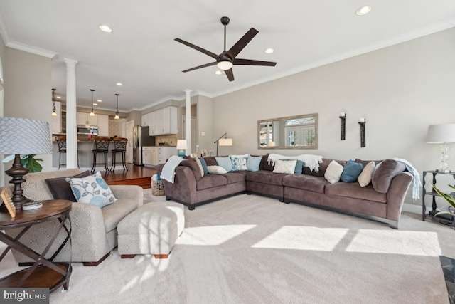 living room with ornamental molding, decorative columns, and ceiling fan