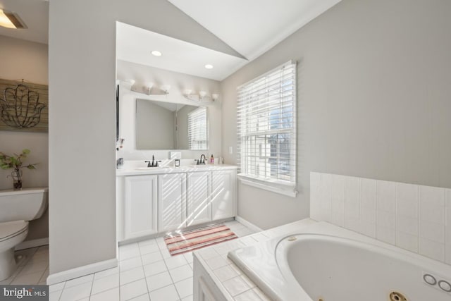 bathroom with toilet, vaulted ceiling, vanity, a relaxing tiled tub, and tile patterned flooring