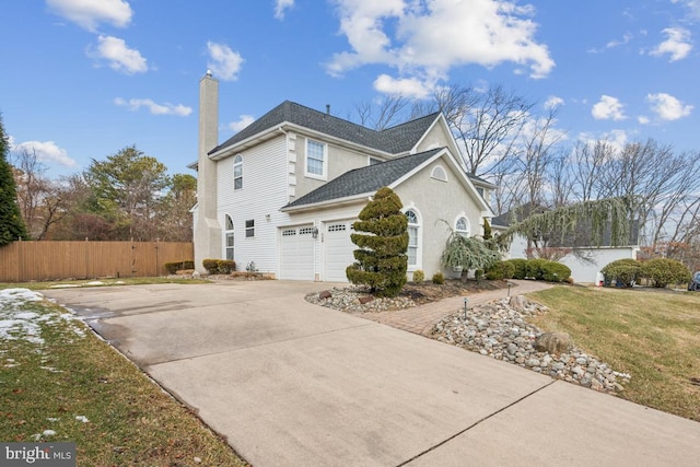 view of home's exterior with a garage and a lawn