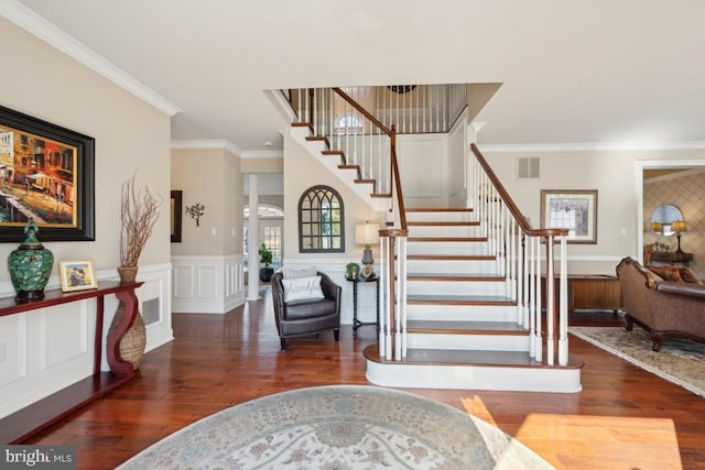 entryway featuring dark wood-type flooring and ornamental molding