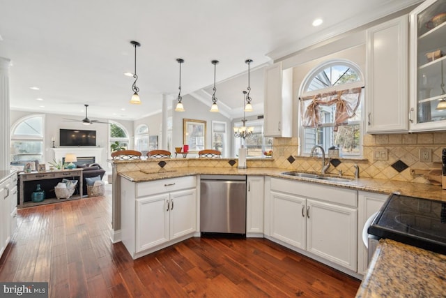 kitchen featuring stainless steel appliances, white cabinetry, hanging light fixtures, and sink