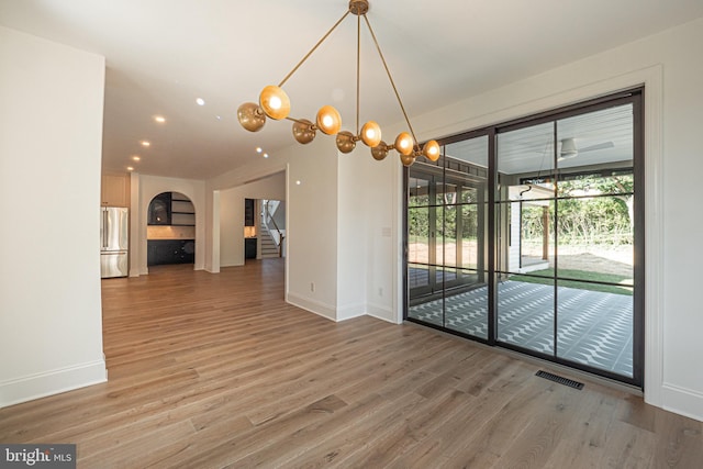 unfurnished dining area featuring hardwood / wood-style flooring