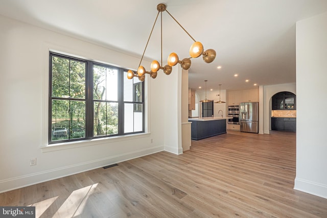 interior space with light hardwood / wood-style floors and sink