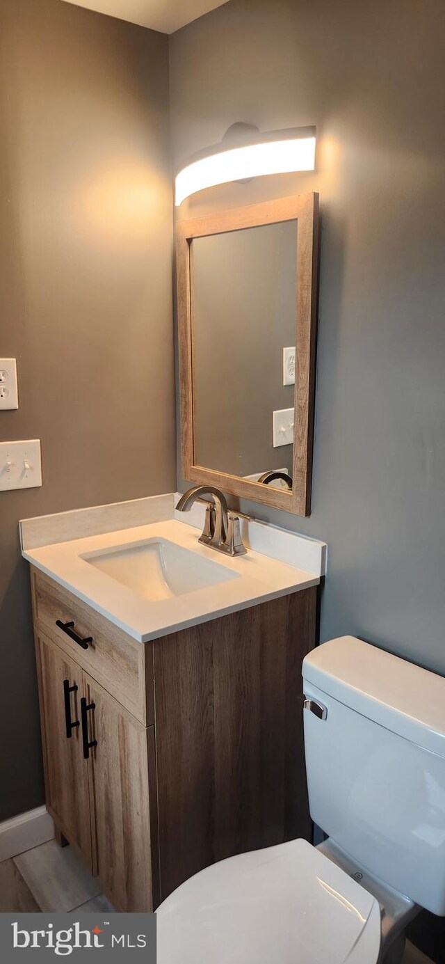 bathroom featuring vanity and toilet