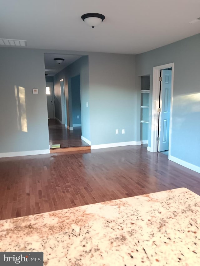 unfurnished room with dark hardwood / wood-style floors