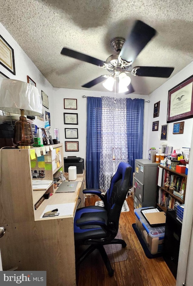 office featuring ceiling fan, hardwood / wood-style floors, and a textured ceiling