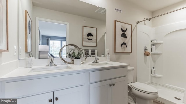 bathroom with vanity, toilet, and walk in shower