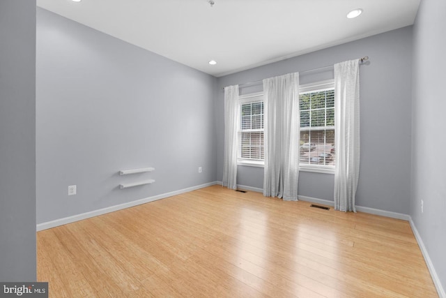 unfurnished room with light wood-type flooring