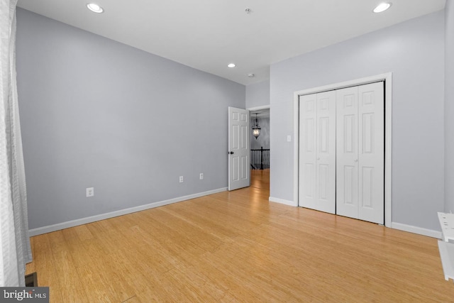 unfurnished bedroom featuring light hardwood / wood-style floors and a closet