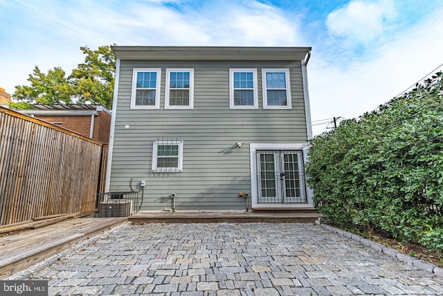 back of property featuring french doors and a patio