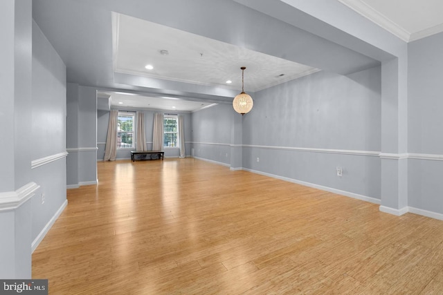 unfurnished living room with light hardwood / wood-style floors and crown molding