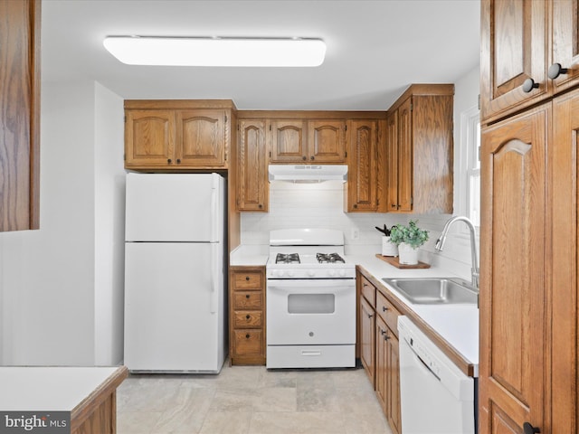 kitchen featuring sink, backsplash, and white appliances