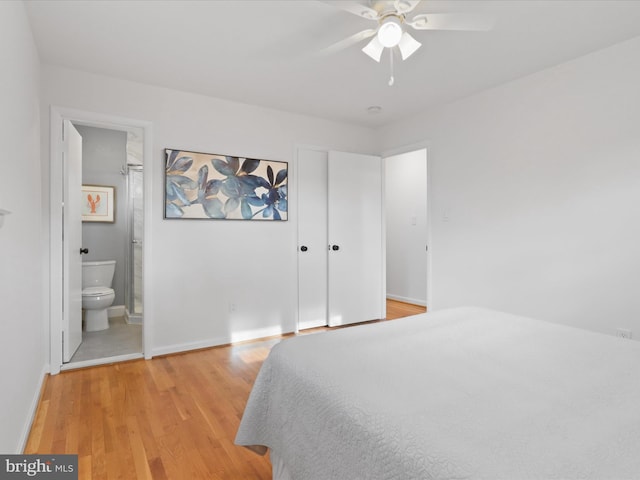 bedroom with ceiling fan, ensuite bath, and light hardwood / wood-style flooring