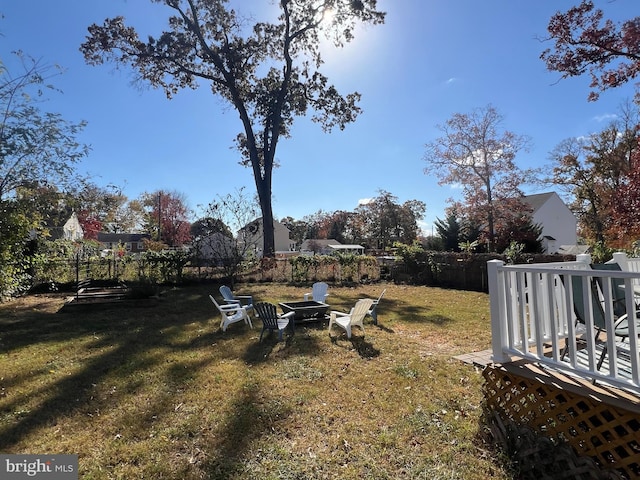 view of yard featuring a fire pit and a wooden deck