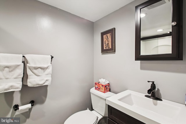 bathroom with toilet and vanity