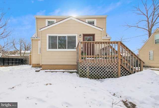 snow covered property with a deck