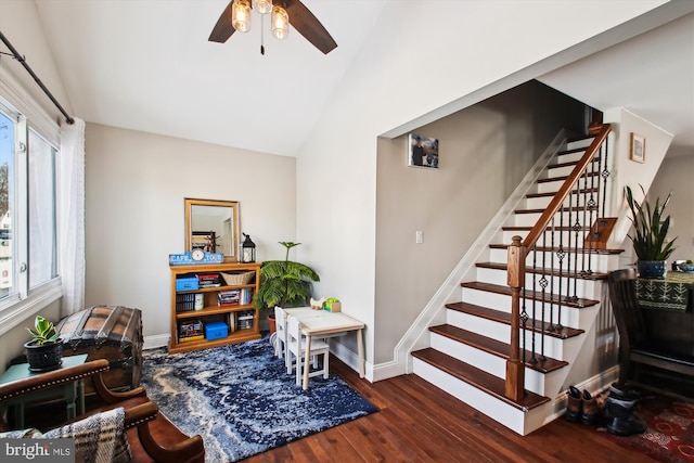 living area with ceiling fan, dark wood-type flooring, and lofted ceiling