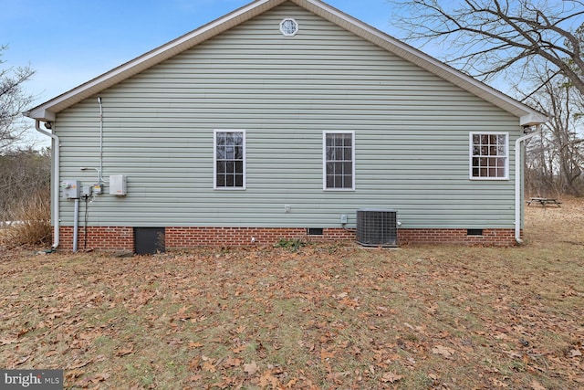 view of side of property featuring central air condition unit